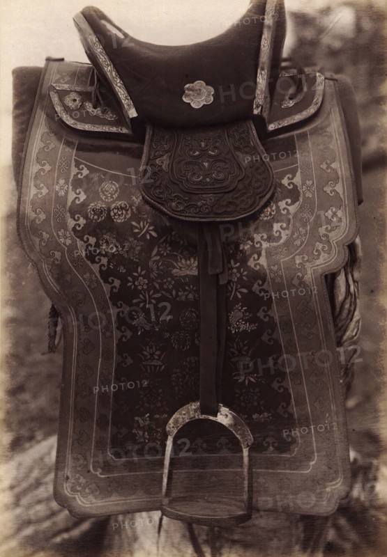 Saddle with Chinese Saddle-Cloth and Silver Mongolia Engraving over Iron, 1897. Creator: Unknown.