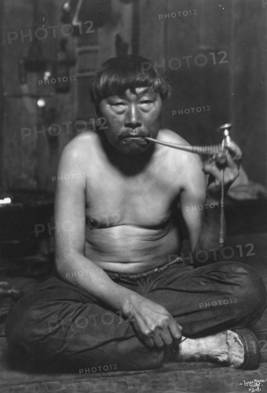 Eskimo smoking pipe, between c1900 and 1927. Creator: Lomen Brothers.