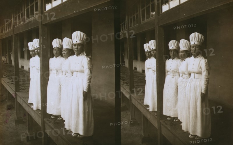 Japanese nurses attending to wounded soldiers in a hospital ward, c1905. Creator: Underwood & Underwood.