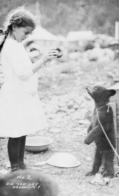 Girl and bear cub, between c1900 and 1916. Creator: Unknown.