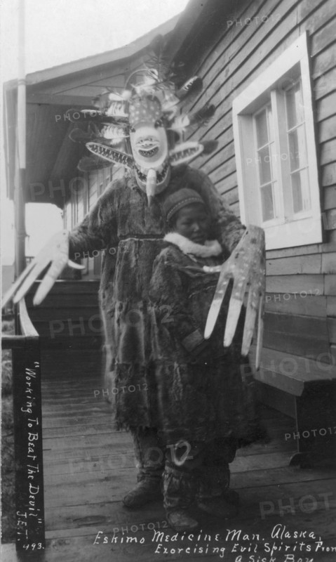 Eskimo medicine man and sick boy, between c1900 and c1930. Creator: Unknown.
