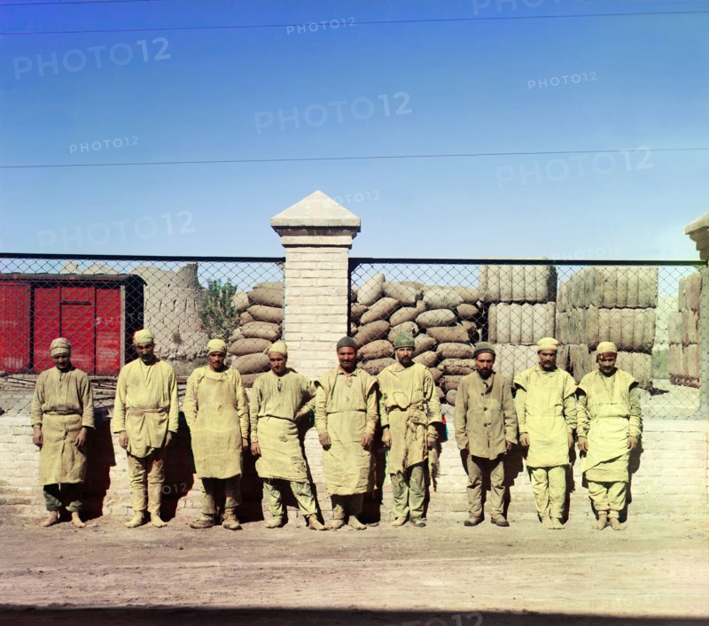 Group of labourers in front of a chain-link fence, between 1905-1915. Creator: Sergey Mikhaylovich Prokudin-Gorsky.