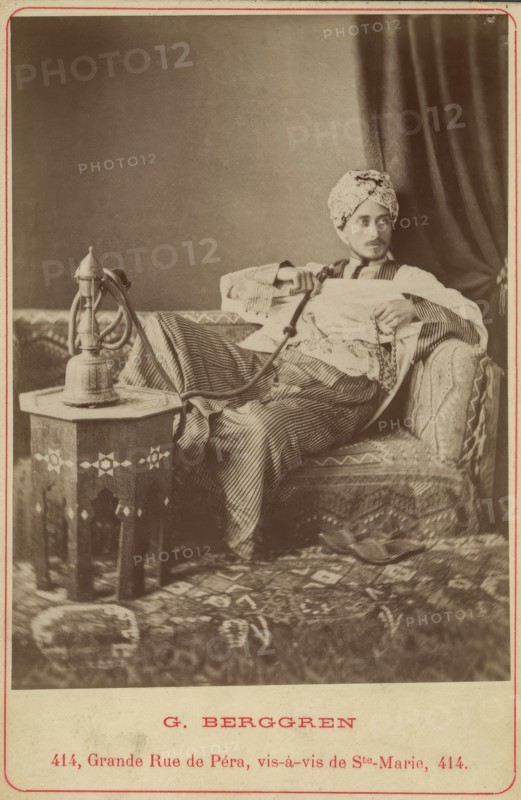 Marquis Claes Lagergren (1853-1930) in eastern costume smoking a hookah. Creator: Guillaume Berggren.