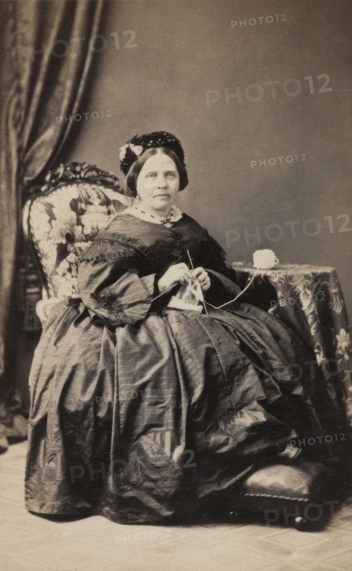 Business card, studio portrait of elderly woman knitting. (c1880s). Creator: Karolina Christianson.