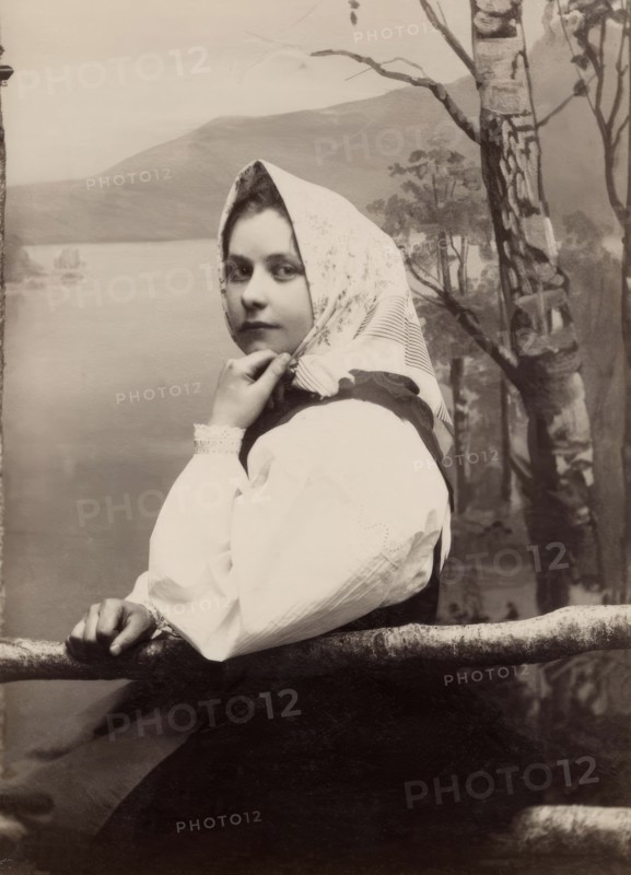 Photograph of a young girl in a white blouse and white headscarf, 1880-1890. Creator: Helene Edlund.