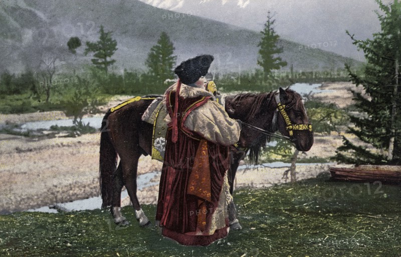 Altai Woman in National Costume (Hat: Kuaraan Boruk, Sheepskin Coat: Ton, Sleeveless..., 1911-1913. Creator: Sergei Ivanovich Borisov.