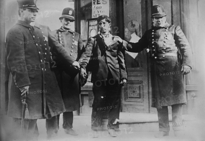 Battered striker with policemen, Philadelphia, 1910. Creator: Bain News Service.