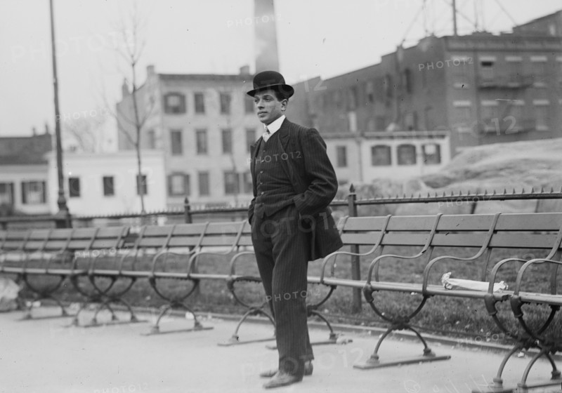 Umberto Blaisie standing in front of park benches, 1910. Creator: Bain News Service.