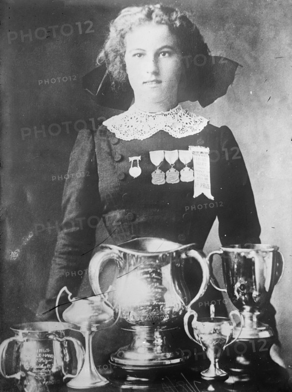 Alsie Aykroyd in front of her trophies, 1910. Creator: Bain News Service.