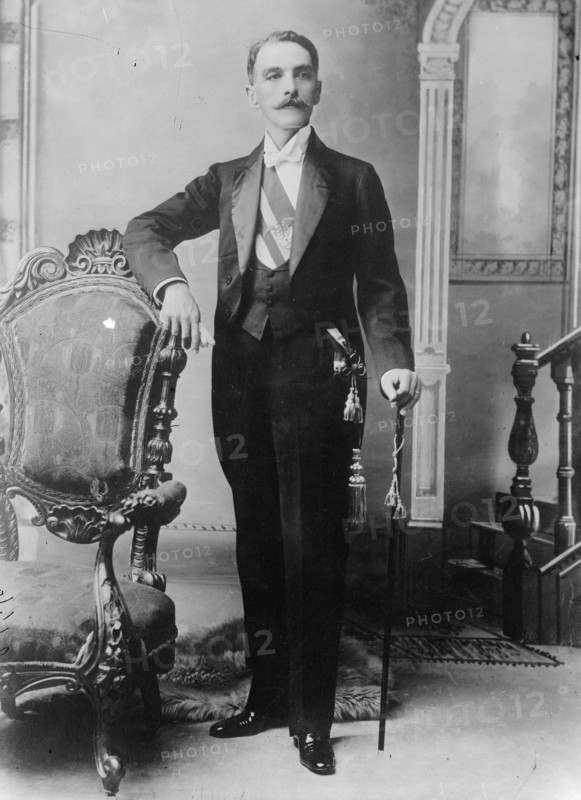 C.E. Restrepo posing next to chair, with cane, 1910. Creator: Bain News Service.