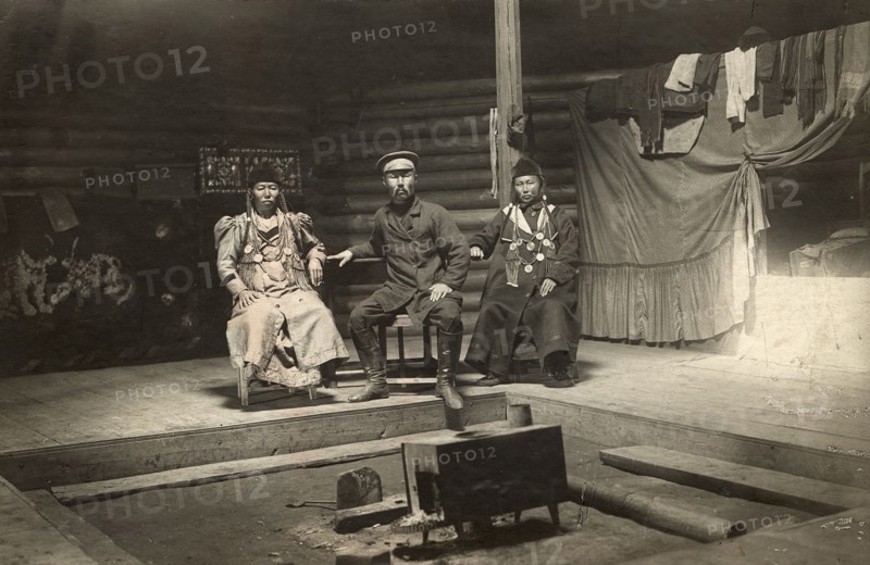 The interior of a Buryat yurt. In the center is a householder with two wives, 1905. Creator: L Veniukov.