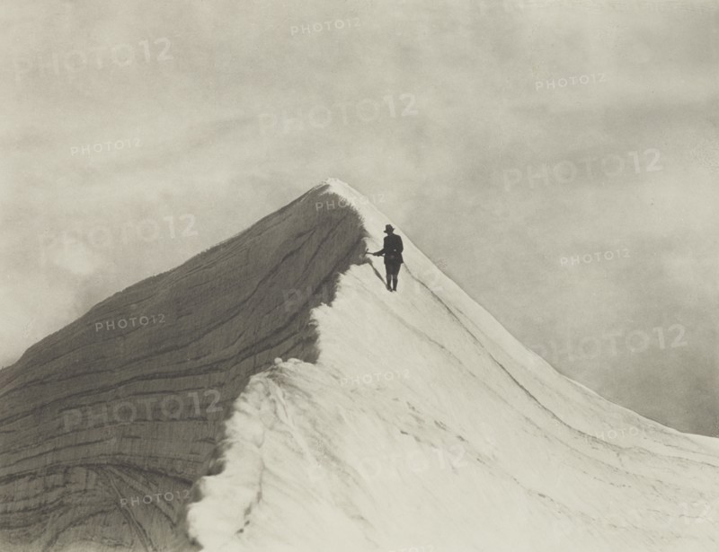 Traversing Annette wind ridge by chief guide F. Milne, Mt Cook district. From the album..., 1920s. Creator: Harry Moult.
