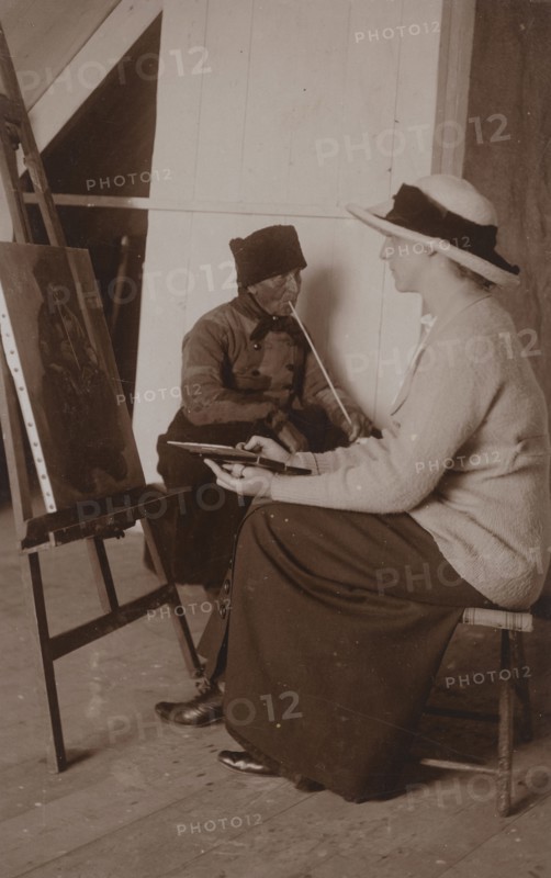Maud Sherwood painting a dutchman with a clay pipe, 1913. Creator: Unknown.