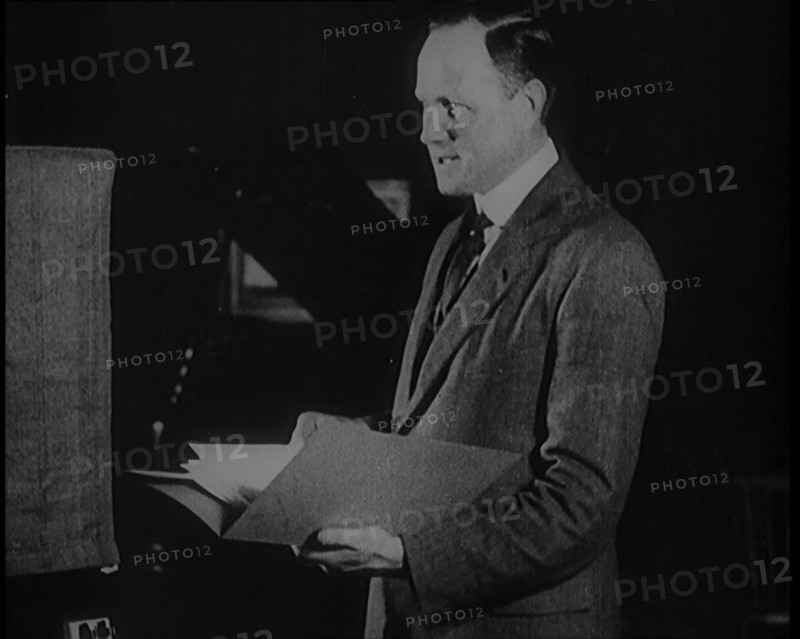 A Man Reading from a Book for the British Broadcasting Corporation, 1922. Creator: British Pathe Ltd.