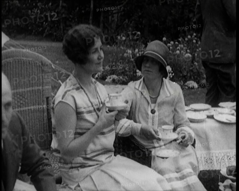 A Group of People Drinking Tea and Eating Cakes in the Garden, 1926. Creator: British Pathe Ltd.