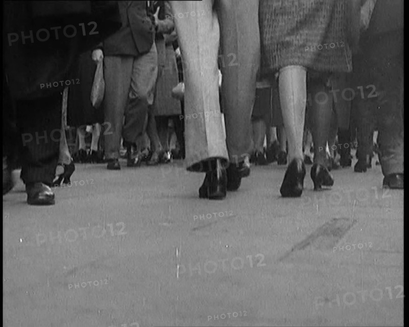 The Shoes and Legs of Crowds of People Walking the Streets of London, 1929. Creator: British Pathe Ltd.