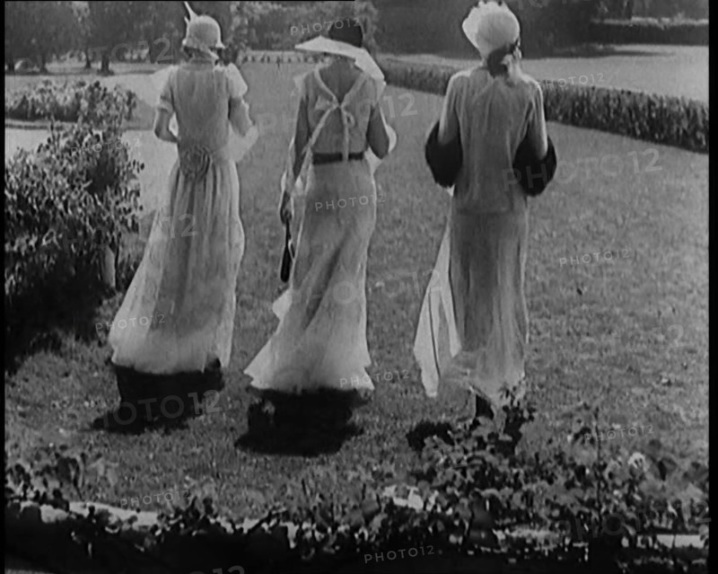 A Group of Three Female Civilians Wearing Fashionable Clothes Standing in a Garden, 1929. Creator: British Pathe Ltd.