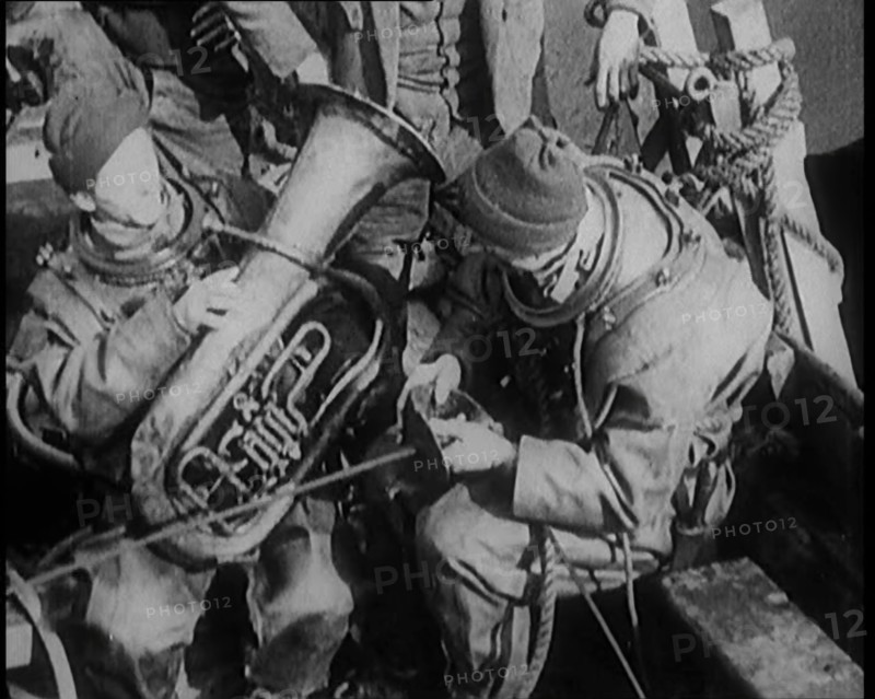 A Diver Coming up from the Sea Carrying a Tuba, 1929. Creator: British Pathe Ltd.