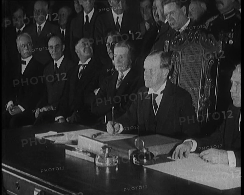 Frank Billings Kellogg Sitting Next to American President Calvin Coolidge Signing the Kellogg...1929 Creator: British Pathe Ltd.