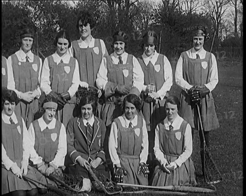 A Group of Young Female Civilians Wearing Gymslips Holding Lacrosse Sticks, 1920. Creator: British Pathe Ltd.