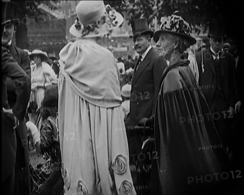 Civilians on the Street Wearing Evening Outfits, Hats and Top Hats, 1920. Creator: British Pathe Ltd.