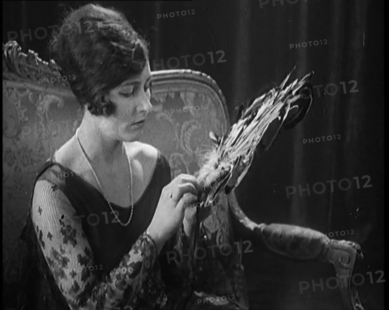 Female Civilian Seating Handling a Fan Made of Feathers, 1920. Creator: British Pathe Ltd.