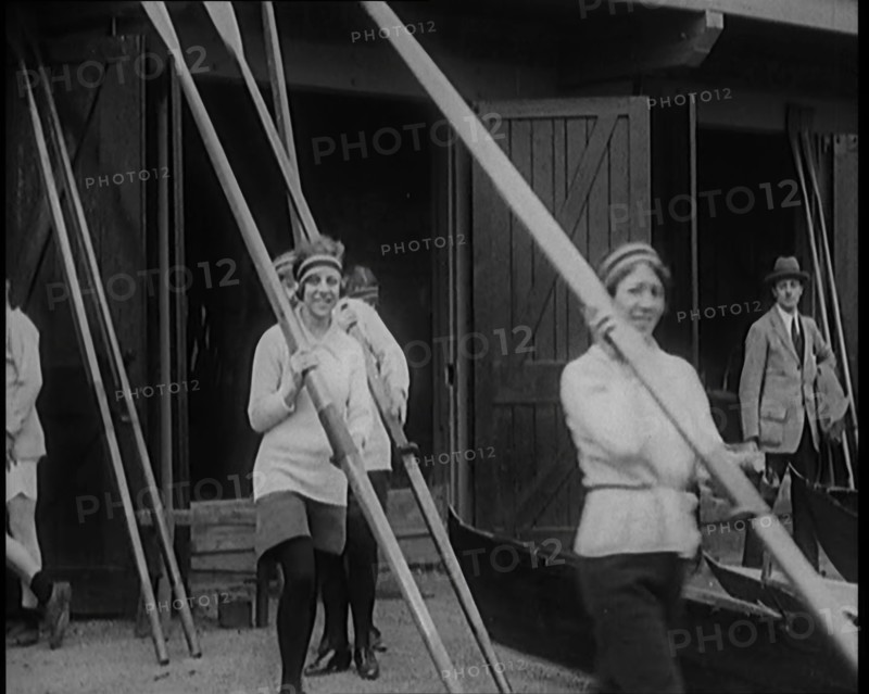 Young Female Civilians Wearing Sport Outfits Carrying Rowing Blades Arriving for a Rowing Class,1920 Creator: British Pathe Ltd.