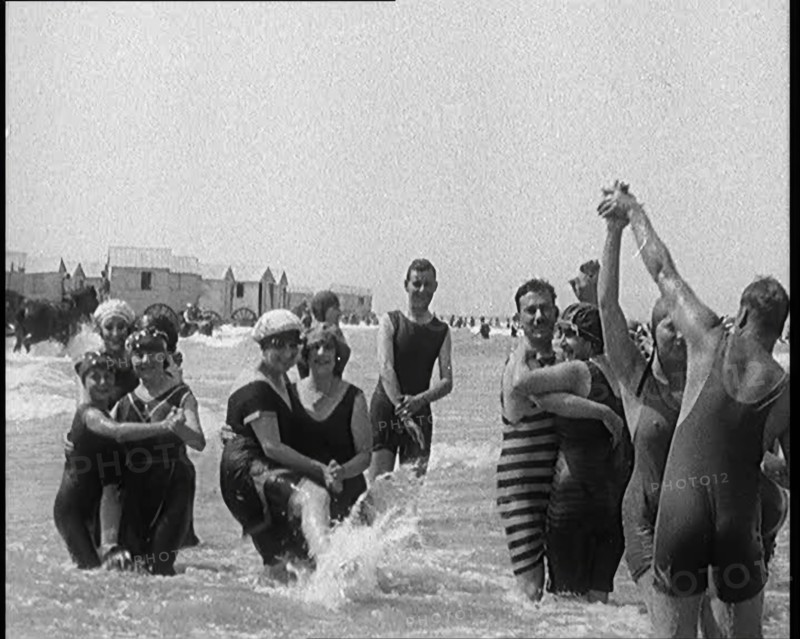 Civilians Wearing Swimsuits Enjoying a Sunny Day Dancing at a Very Crowded Beach, 1920. Creator: British Pathe Ltd.