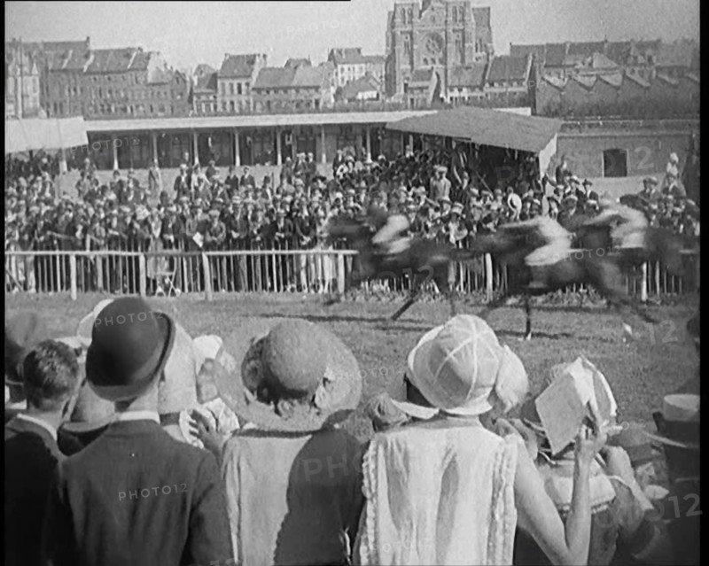 A Large Crowd of Civilians Wearing Smart Outfits and Hats Watching a Horse Race, 1920. Creator: British Pathe Ltd.