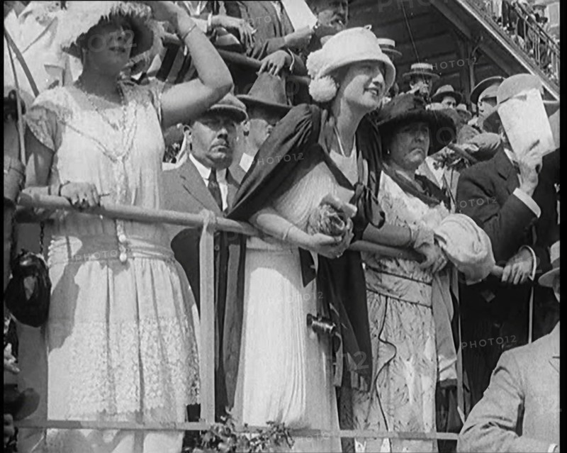 A Large Crowd of Civilians Wearing Smart Outfits and Hats Watching a Horse Race, 1920. Creator: British Pathe Ltd.