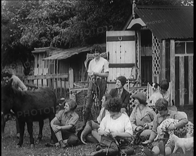 A Group of Young Female Civilians Sitting Outdoors with Various Animals Around Them, 1920. Creator: British Pathe Ltd.