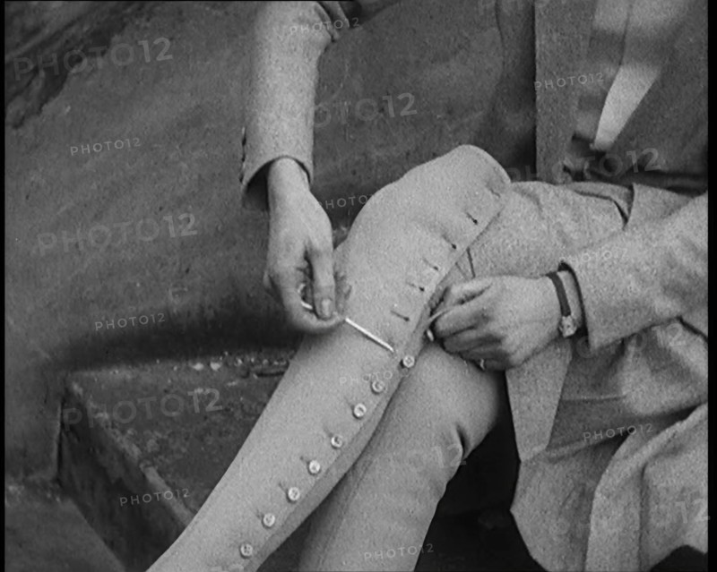 Female Civilian Using a Button Hook to Button up Her Leather Boots, 1920. Creator: British Pathe Ltd.