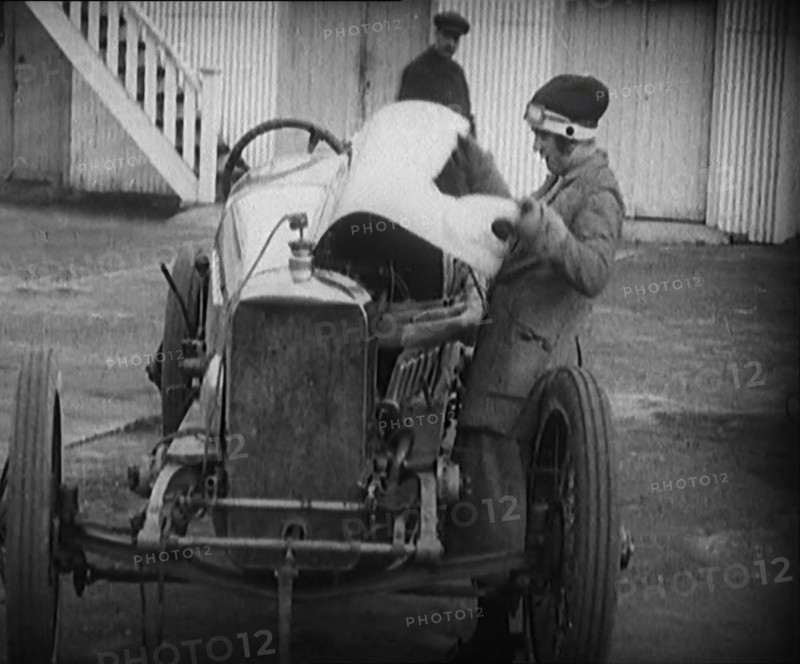 Racing Driver Ivy Cummins Wearing a Racing Outfit Opening a Bonnet of Her Car, 1920. Creator: British Pathe Ltd.