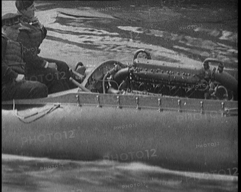 Marion Barbara 'Joe' Carstairs on a Speedboat with a Male Civilian Passenger, 1920. Creator: British Pathe Ltd.