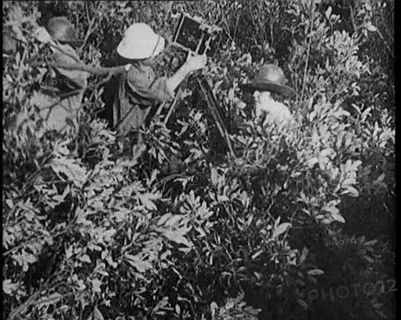 Female Civilians Wearing Explorers Outfit Setting up a Camera to Record Nature Life in the..., 1920. Creator: British Pathe Ltd.
