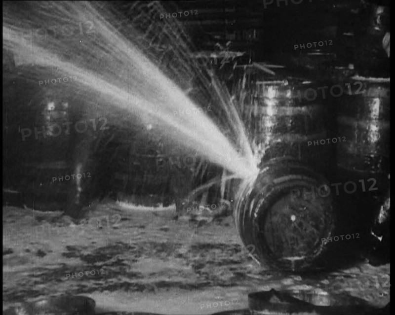 Barrels of Alcohol in a Cellar Being Destroyed During Prohibition, 1930. Creator: British Pathe Ltd.