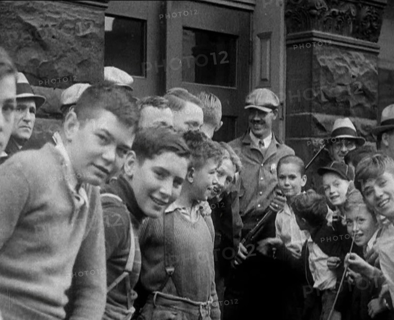 A Group of American Children Civilians Gathering Outside an Official Building with a Male..., 1930. Creator: British Pathe Ltd.