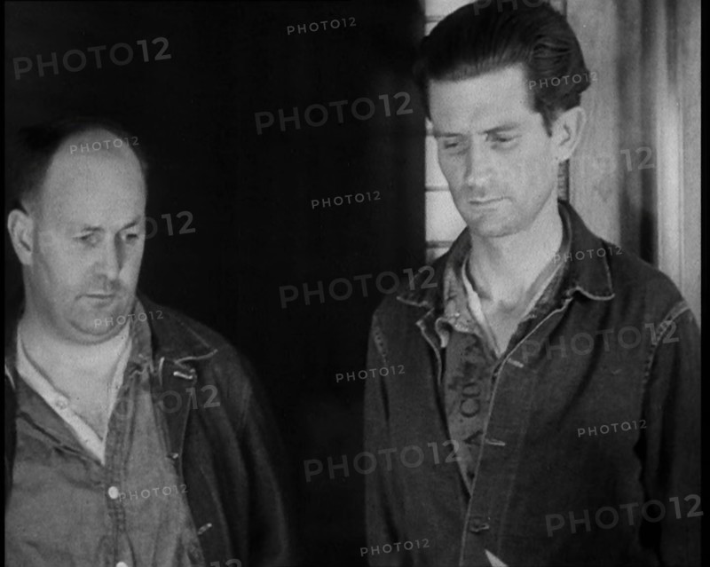 A group of Male Americans Civilians Wearing Prisoners Outfits Being Escorted Into a Room..., 1930. Creator: British Pathe Ltd.