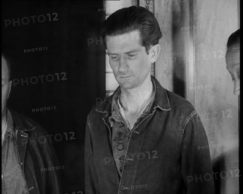 A group of Male Americans Civilians Wearing Prisoners Outfits Being Escorted Into a Room..., 1930. Creator: British Pathe Ltd.