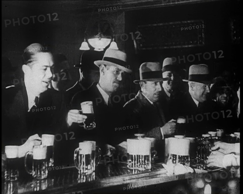 American Civilians Celebrating the End of Prohibition Drinking in a Bar, 1930s. Creator: British Pathe Ltd.