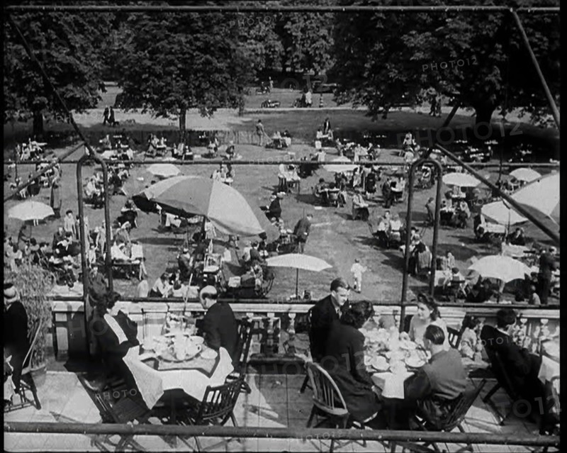 People Sitting at Tables on a Balcony While Another Group of People Sit Below, 1933. Creator: British Pathe Ltd.