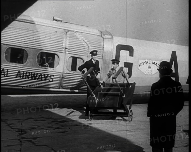 Three Men Tending to a Plane on the Ground, 1933. Creator: British Pathe Ltd.