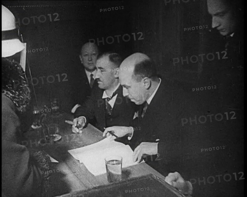 Woman Talking to Four Men Sitting at a Desk, 1933. Creator: British Pathe Ltd.