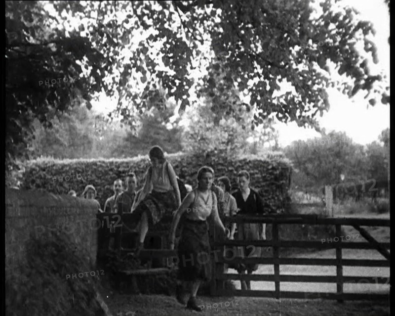 Hikers Climbing over a Gate, 1933. Creator: British Pathe Ltd.