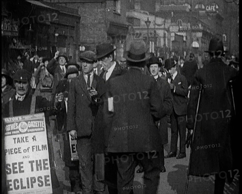 Men Wearing 'Pathe Gazette' Sandwich Boards Handing Out Pieces of Polaroid Film to Crowds..., 1921. Creator: British Pathe Ltd.