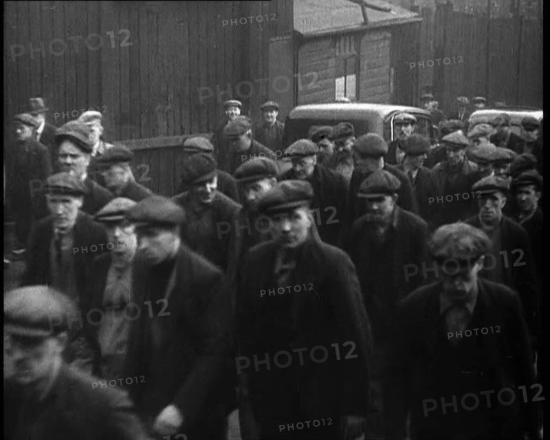 Crowd of Men Walking Through the Street Towards the Camera, 1933. Creator: British Pathe Ltd.