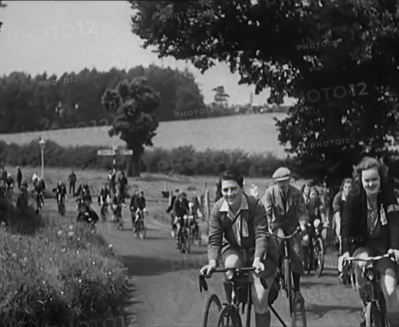 Large Group of Civilians Riding Bicycles Through Country Lanes, 1931. Creator: British Pathe Ltd.