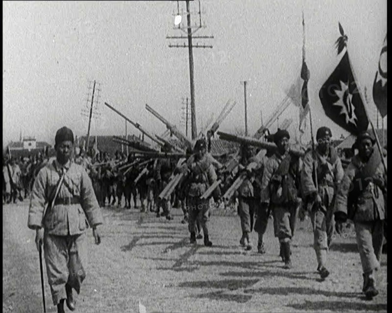 Chinese Soldiers Marching Carrying Flags and Other Equipment, 1920s. Creator: British Pathe Ltd.