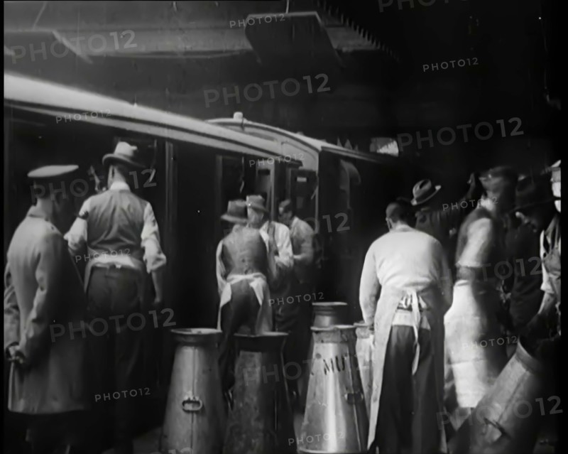 Volunteer Male Civilians Lifting Milk Churns and Helping Deliver Milk, 1926. Creator: British Pathe Ltd.