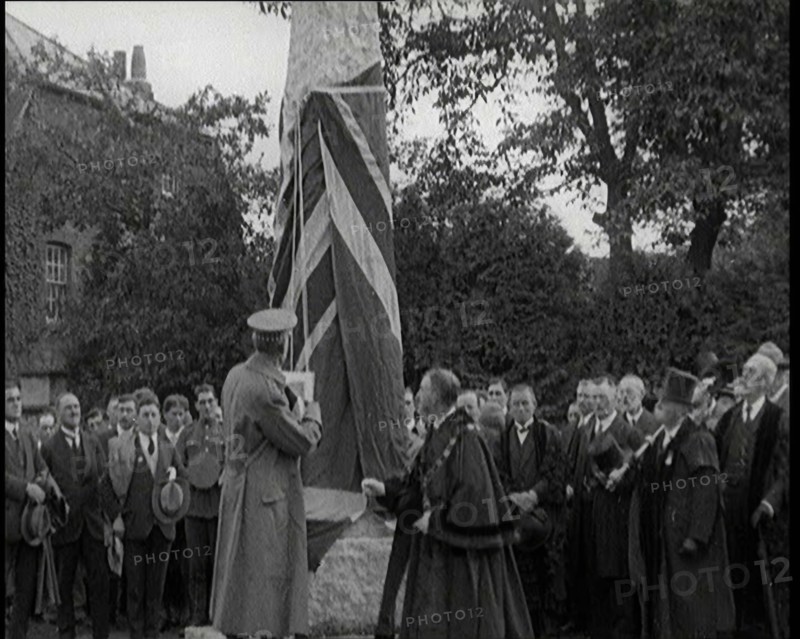 British Officer Pulling Down Union Flag to Reveal a Memorial Obelisk, 1920. Creator: British Pathe Ltd.